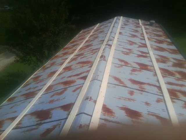 Rusted metal roof panels with new wood purlins before replacement — Storm Damage Roof Repair in Sherrodsville by Roofing Brothers
